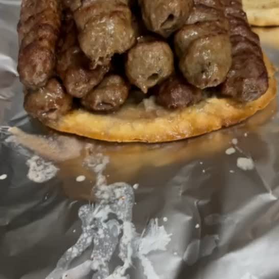Grilled meat served over flatbread